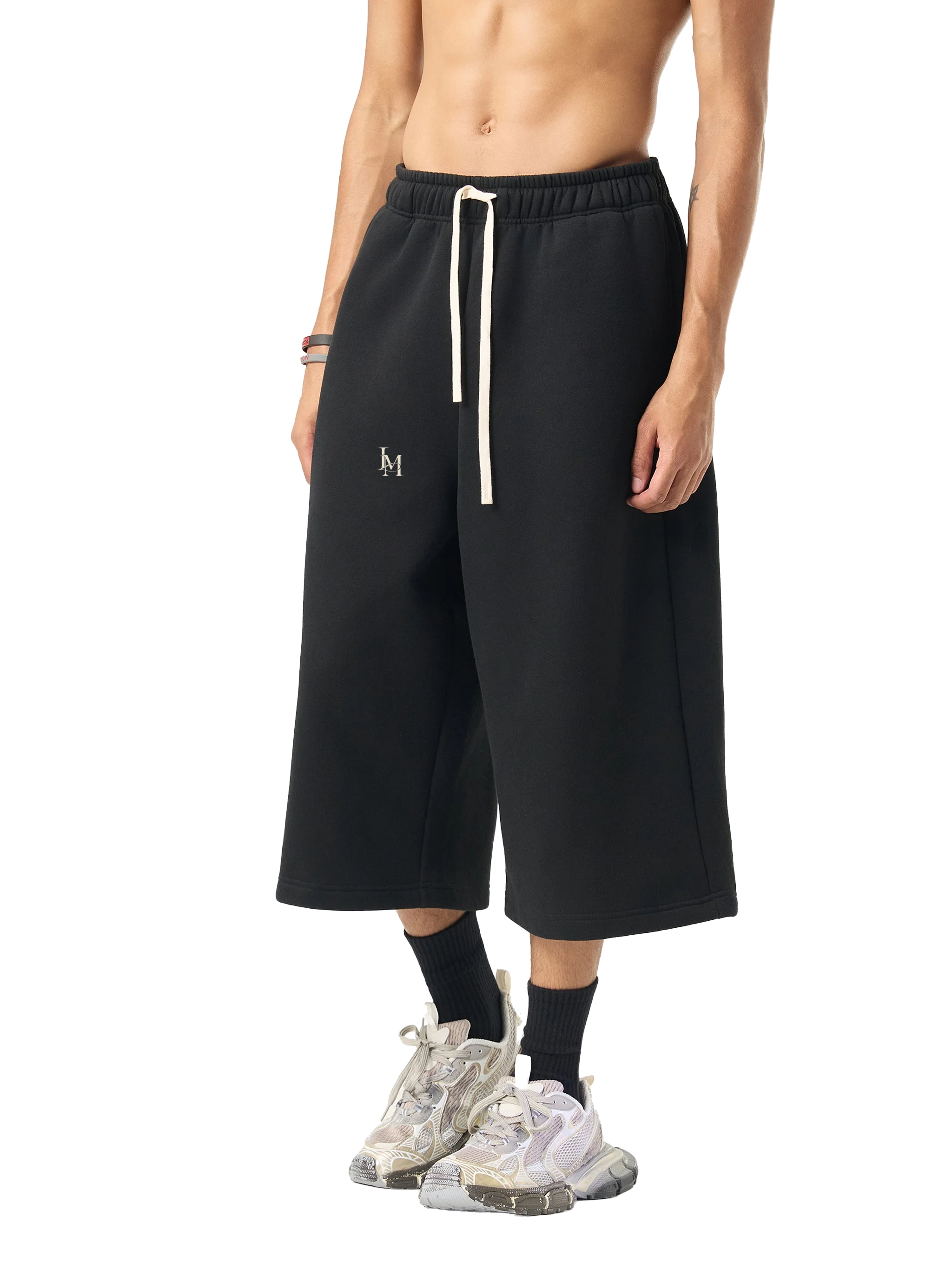 The Three-Quarter Sweatpant in Black — on model, front #Color_Black