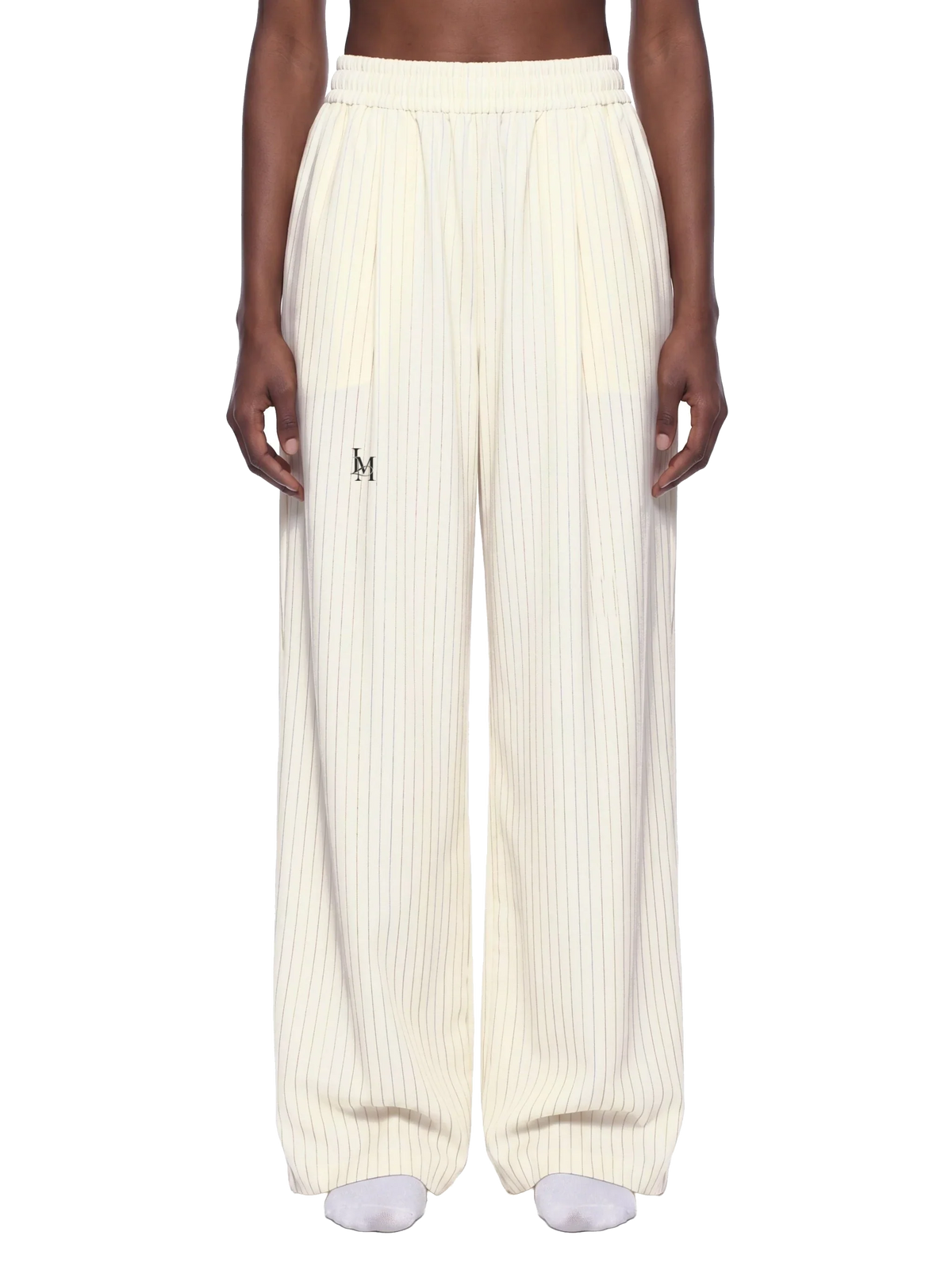 The Pleated Trouser in White — on model, front #Color_White