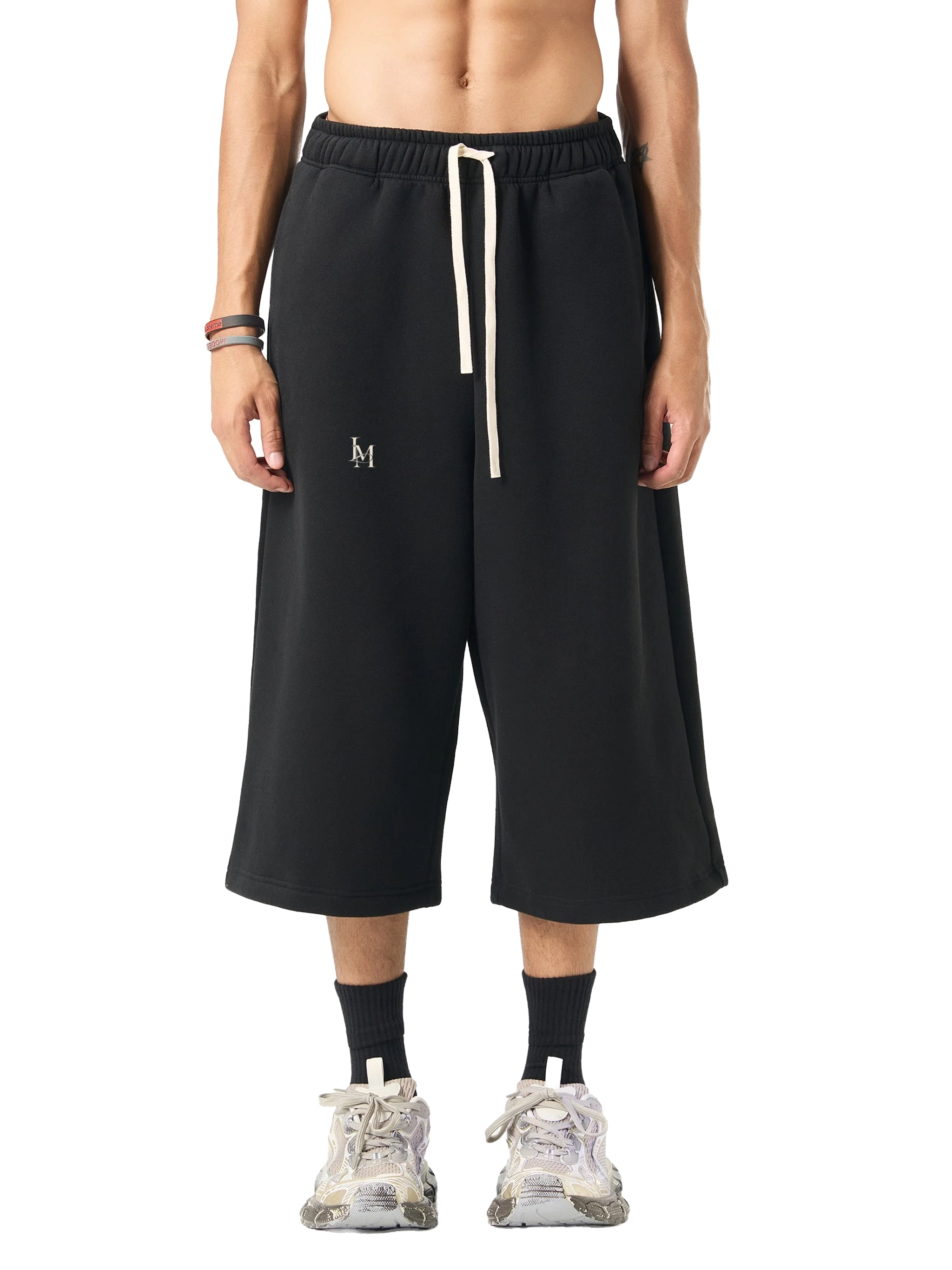 The Three-Quarter Sweatpant in Black — on model, front #Color_Black